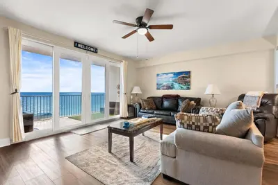 a living room with a view of the ocean at Gulf-View Resort Condo with Pools & Beach Access by Dolce Vita Getaways in Panama City Beach