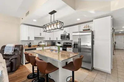 a kitchen with a large island in the middle at Gulf-View Resort Condo with Pools & Beach Access by Dolce Vita Getaways in Panama City Beach