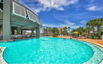 a large swimming pool in a resort with people in it at Gulf-View Resort Condo with Pools & Beach Access by Dolce Vita Getaways in Panama City Beach