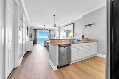 a kitchen with white cabinets and a counter top at Ocean Reef 2203 by Emerald Coast Retreats in Panama City Beach