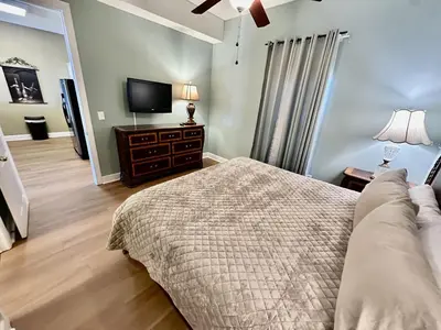 a bedroom with a bed and a flat screen tv at Ocean Reef 2203 by Emerald Coast Retreats in Panama City Beach