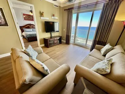 a living room with two couches and a television at Ocean Reef 2203 by Emerald Coast Retreats in Panama City Beach