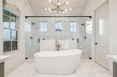 a white bathroom with a tub and a shower at Katydid Beach Bungalow by 30A Escapes in Seagrove Beach