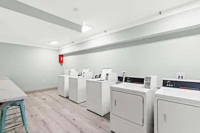 a room with a row of washers and dryers at The Summit 1421 - Wake to Gulf Views in Panama City Beach