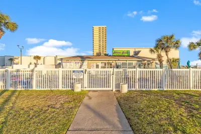 a white fence in front of a building at The Summit 1421 - Wake to Gulf Views in Panama City Beach