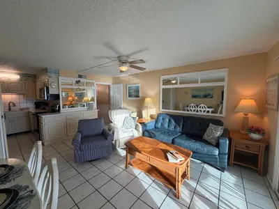 a living room with a couch and a table at The Summit 830 - Ocean Front Condo in Panama City Beach