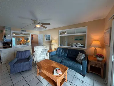 a living room with a couch and a table at The Summit 830 - Ocean Front Condo in Panama City Beach