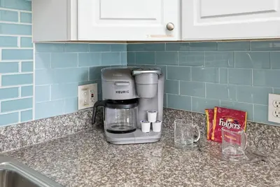 a coffee maker on a counter in a kitchen at The Summit 926 - One Bedroom Beachfront Condo in Panama City Beach