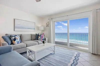 a living room with a view of the ocean at The Summit 926 - One Bedroom Beachfront Condo in Panama City Beach