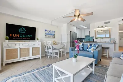 a living room with a couch and a table at The Summit 926 - One Bedroom Beachfront Condo in Panama City Beach
