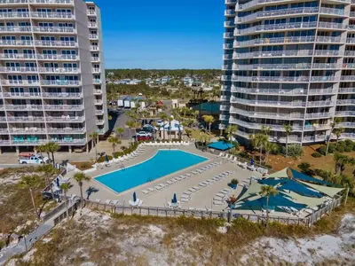 an aerial view of a pool in front of some buildings at Dunes of Panama C104 - First Floor Gem in Panama City Beach