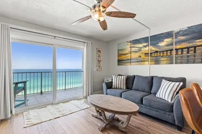 a living room with a couch and a table at The Summit 1419 - Gulf View Escape in Panama City Beach