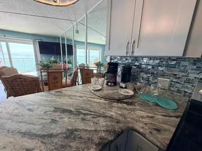a kitchen with a marble counter top in a room at The Summit 1132 - Beachfront Bliss Stunning 2BR in Panama City Beach