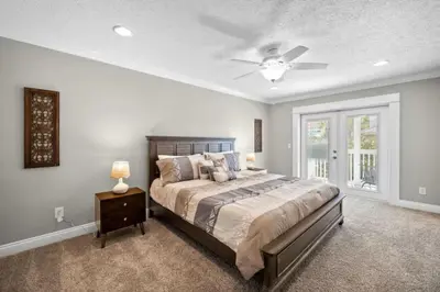 a bedroom with a bed and a ceiling fan at Beach Access - Pool - Game Room - Pets - BBQ Grill in Panama City Beach