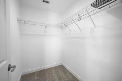a white room with a shelf on the wall at Beach Access - Pool - Game Room - Pets - BBQ Grill in Panama City Beach