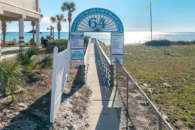 a sign at the beach with the ocean in the background at Walk to the Beach - BBQ - Patio - Play Area - Pets in Panama City Beach