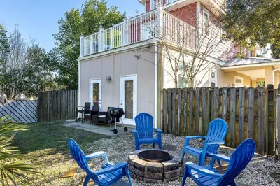 a group of blue chairs sitting around a fire pit at Walk to the Beach - BBQ - Patio - Play Area - Pets in Panama City Beach