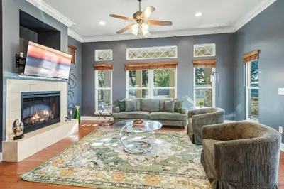 a living room with a couch and a fireplace at Walk to the Beach - BBQ - Patio - Play Area - Pets in Panama City Beach