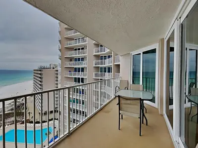 a balcony with a desk and a view of the beach at Dunes of Panama #E1405 in Panama City Beach