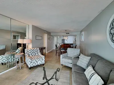 a living room with a couch and chairs and a table at Dunes of Panama #E1405 in Panama City Beach