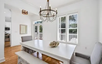 a dining room with a white table and chairs at A Villa La La in Santa Rosa Beach