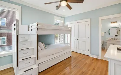 a bedroom with a bunk bed with a ceiling fan at A Villa La La in Santa Rosa Beach
