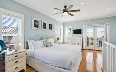 a bedroom with a bed and a ceiling fan at A Villa La La in Santa Rosa Beach