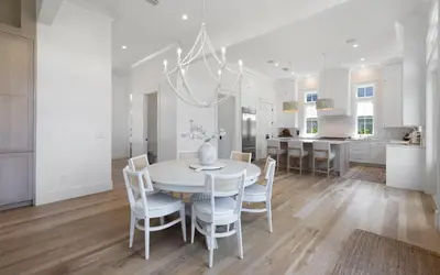 a kitchen and dining room with a white table and chairs at APRÉS 30A in Santa Rosa Beach