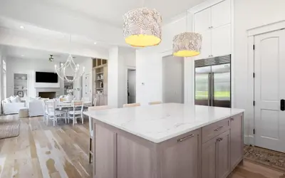 a kitchen and living room with a large white island at APRÉS 30A in Santa Rosa Beach
