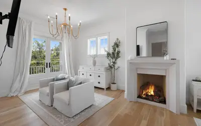 a living room with a fireplace and a couch and a mirror at APRÉS 30A in Santa Rosa Beach