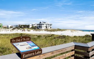 a sign on a bench in front of a beach at APRÉS 30A in Santa Rosa Beach