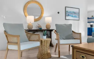 a living room with two chairs and a table at Barsealona in Santa Rosa Beach
