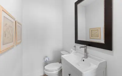 a bathroom with a white toilet and a sink at Barsealona in Santa Rosa Beach