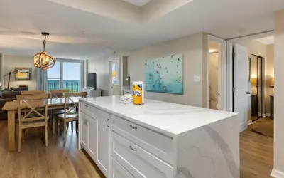 a kitchen with a white counter and a dining room at Beachcrest 202 in Santa Rosa Beach
