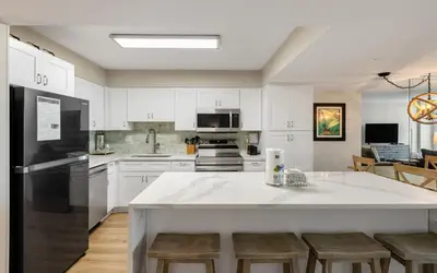 a kitchen with white cabinets and a large white counter top at Beachcrest 202 in Santa Rosa Beach