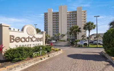 a sign for the beach crest hotel in front of a building at Beachcrest 202 in Santa Rosa Beach