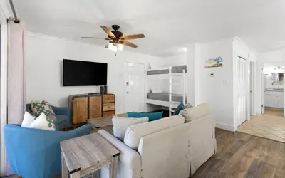 a living room with a couch and a ceiling fan at Beachwood 8G in Santa Rosa Beach
