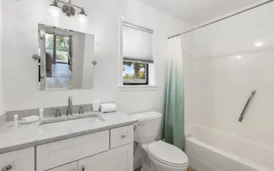 a bathroom with a toilet and a sink and a shower at Beachwood 8G in Santa Rosa Beach