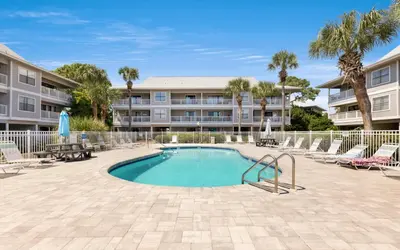a swimming pool with lounge chairs and a building at Beachwood 8G in Santa Rosa Beach