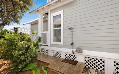 a front porch of a house with a window at Cottage Breeze in Rosemary Beach