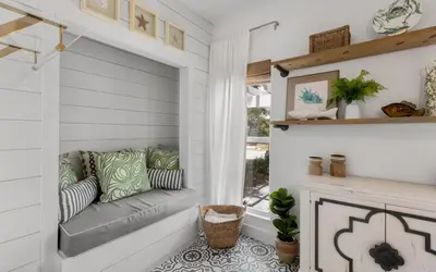 a living room with a couch and a fireplace at Cottage Breeze in Rosemary Beach