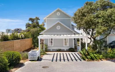 a white house with a white pergola at Cottage Breeze in Rosemary Beach