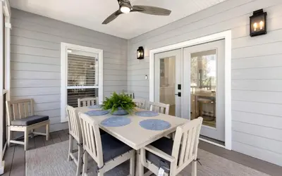 a dining room with a table and chairs at Crown Jules in Santa Rosa Beach
