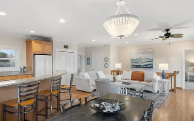 a kitchen and living room with a table and chairs at Ethridge House in Santa Rosa Beach