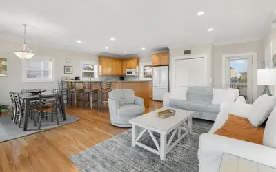 a living room with a couch and a table at Ethridge House in Santa Rosa Beach