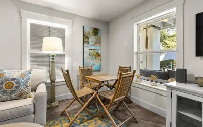 a living room with a table and chairs and a couch at Four Palms in Santa Rosa Beach