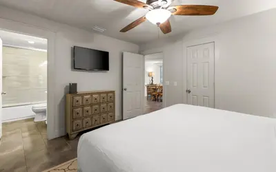 a bedroom with a bed and a ceiling fan at Four Palms in Santa Rosa Beach
