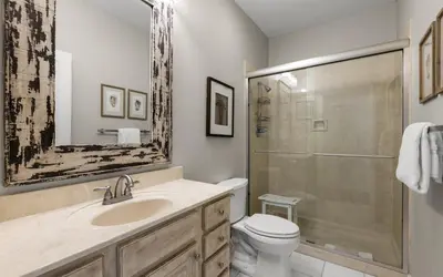 a bathroom with a toilet and a sink and a shower at Four Palms in Santa Rosa Beach