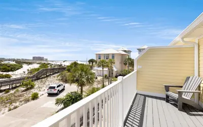 a balcony with a view of the beach at Happy Oasis in Inlet Beach