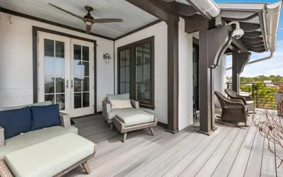 a screened porch with a couch and chairs on a house at Heaven on Pointe in Santa Rosa Beach